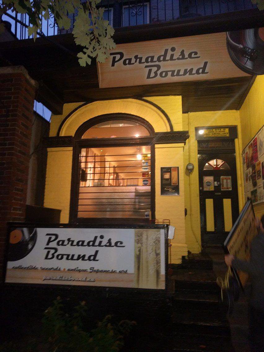 Yellow exterior of Paradise Brown with large jukebox-shaped window.
