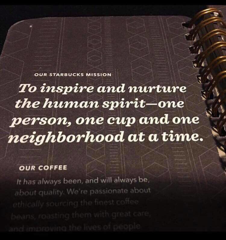 Paper in book from Starbucks Coffee reading "to inspire and nurture the human spirit- one person, one cup and one neighbourhood at a time".