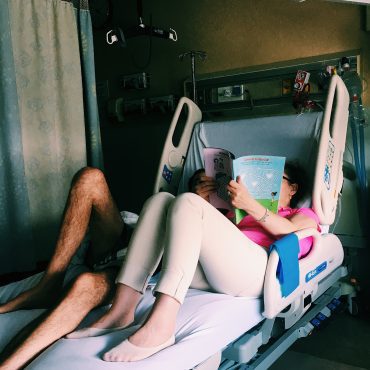 Family members laying down in hospital bed