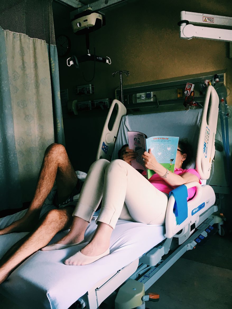 Family members laying down in hospital bed