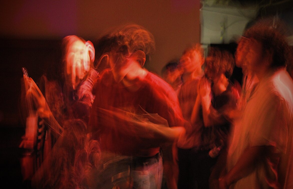 Blurry photo of people dancing. 

