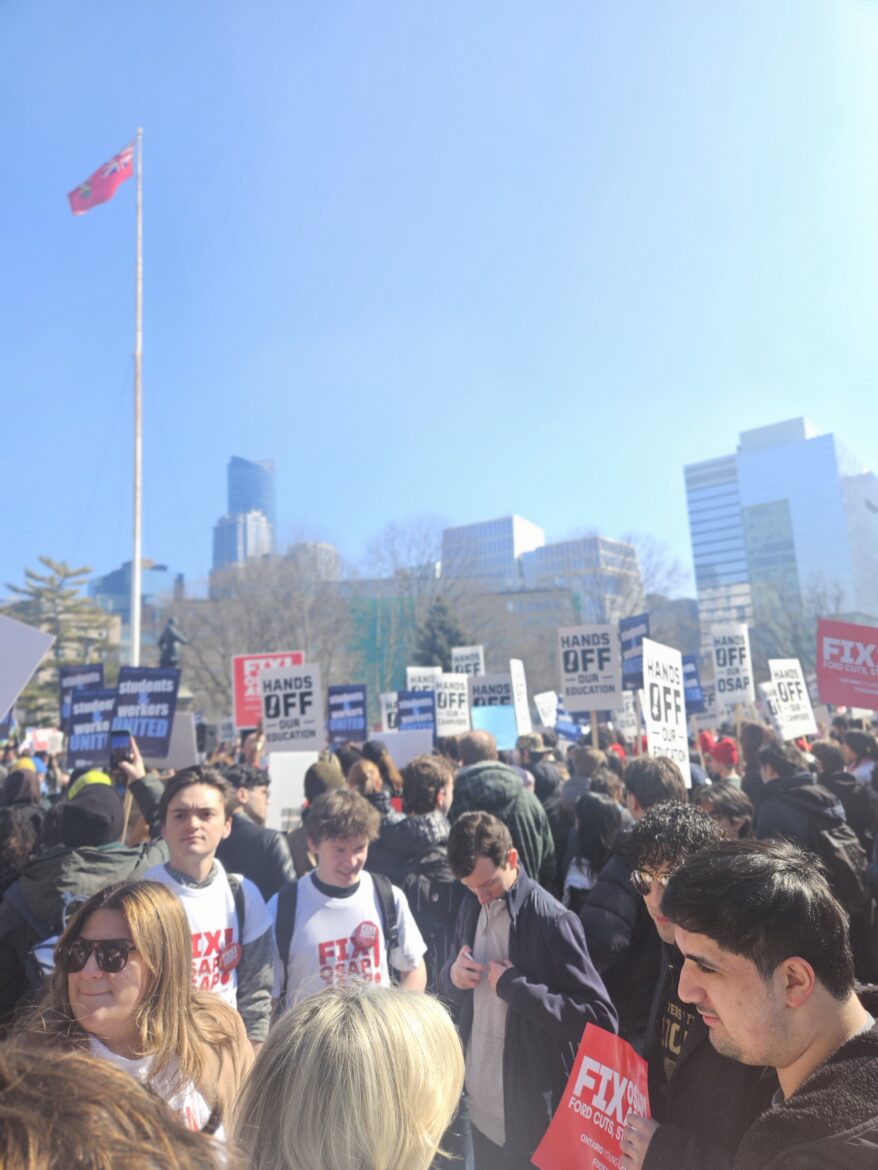 students protesting holding several signs in a big group