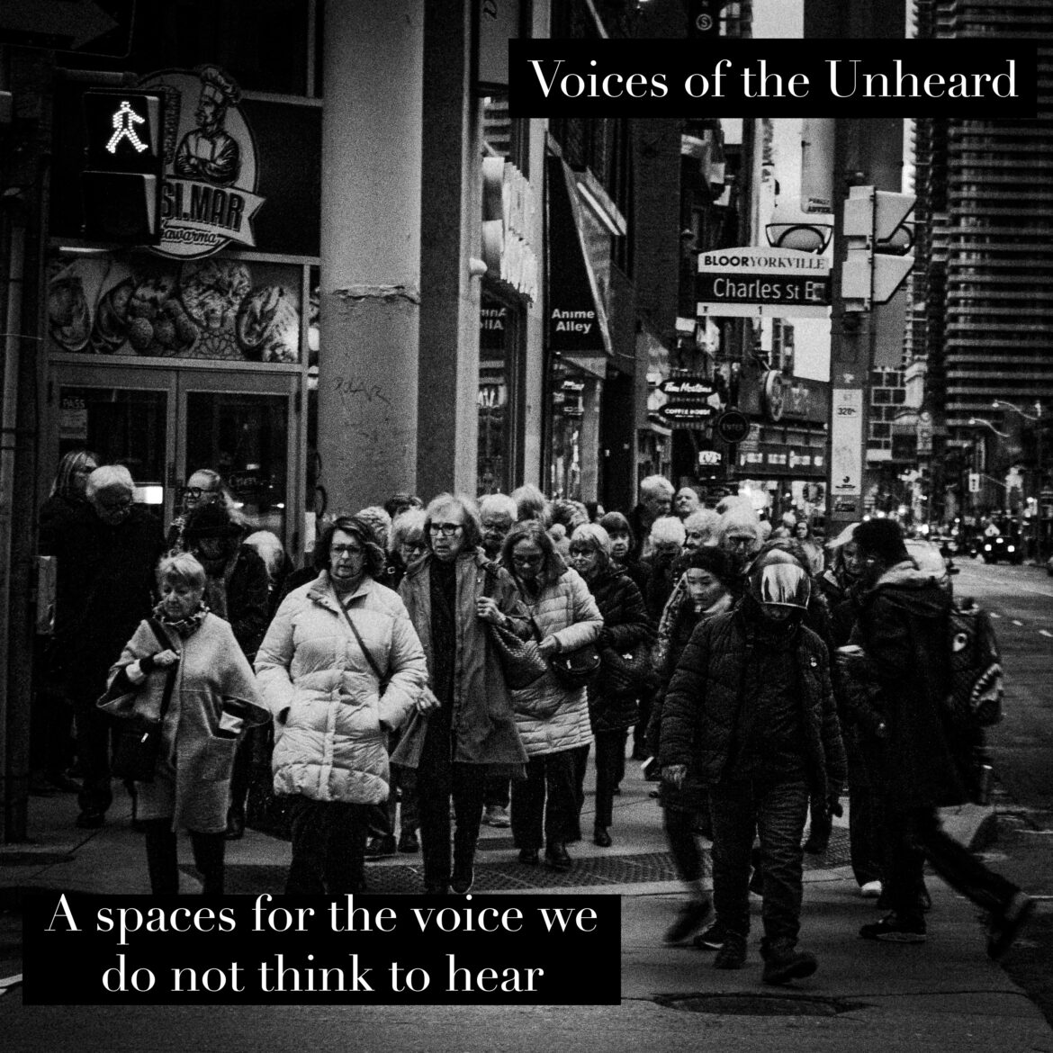 photo of a group of people walking towards the camera at a crosswalk. The photo is in bla